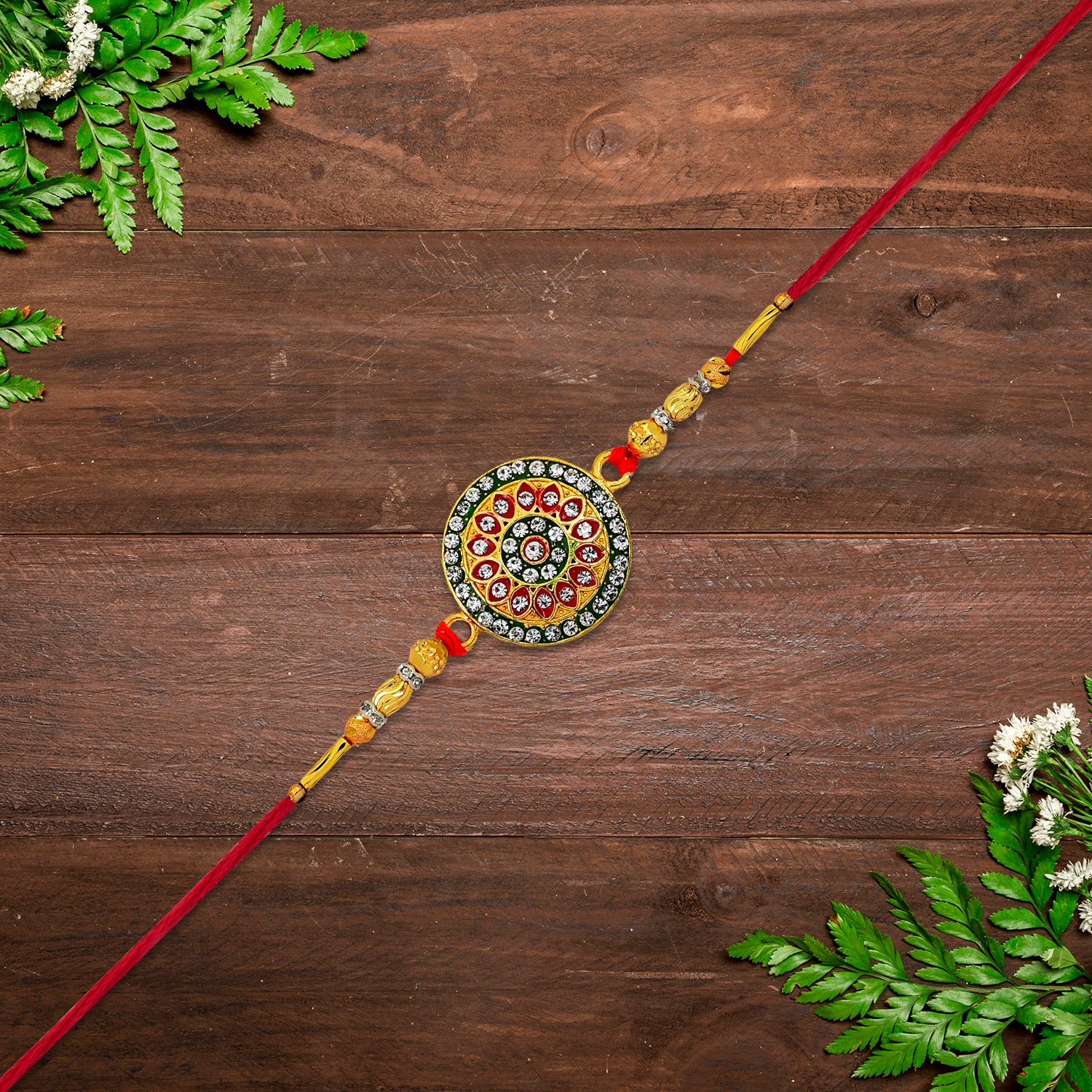 Royal Designer Rakhi With Kundan Centerpiece Red  Green Enamel Work And Golden Beads Royal Designer Rakhi With Kundan Centerpiece Red  Green Enamel Work And Golden Beads